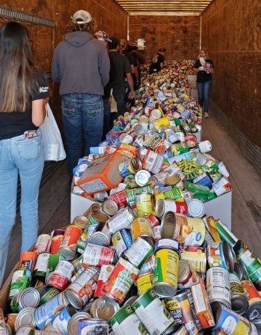 People enter a trailer full of food during the Husker Harvest Days Food Drive in 2024.