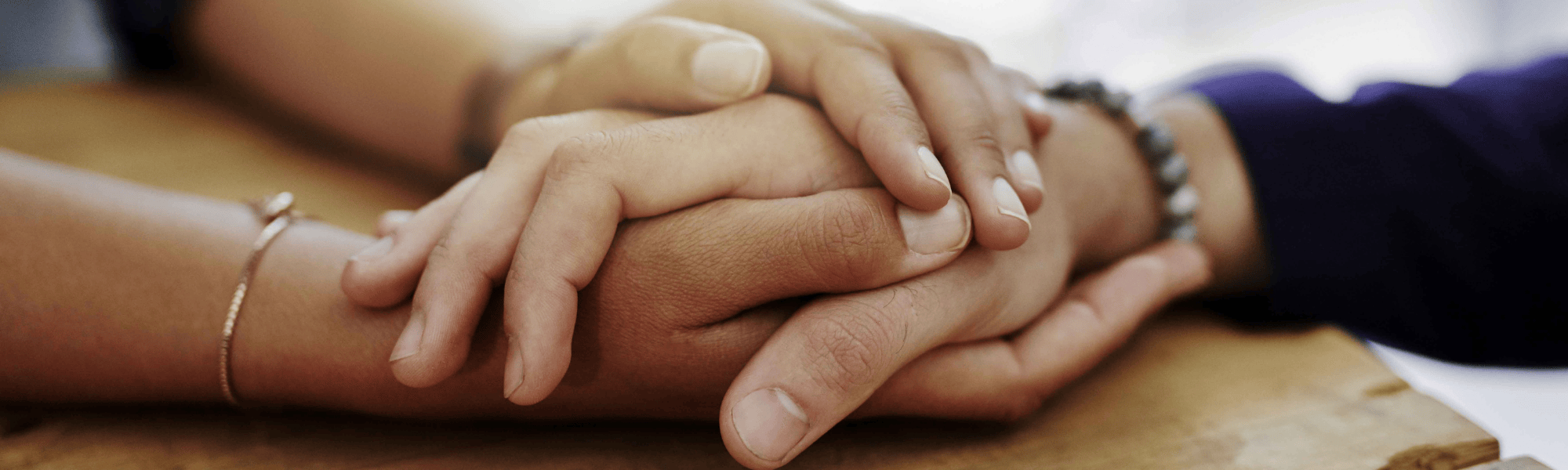 Holding hands on a table
