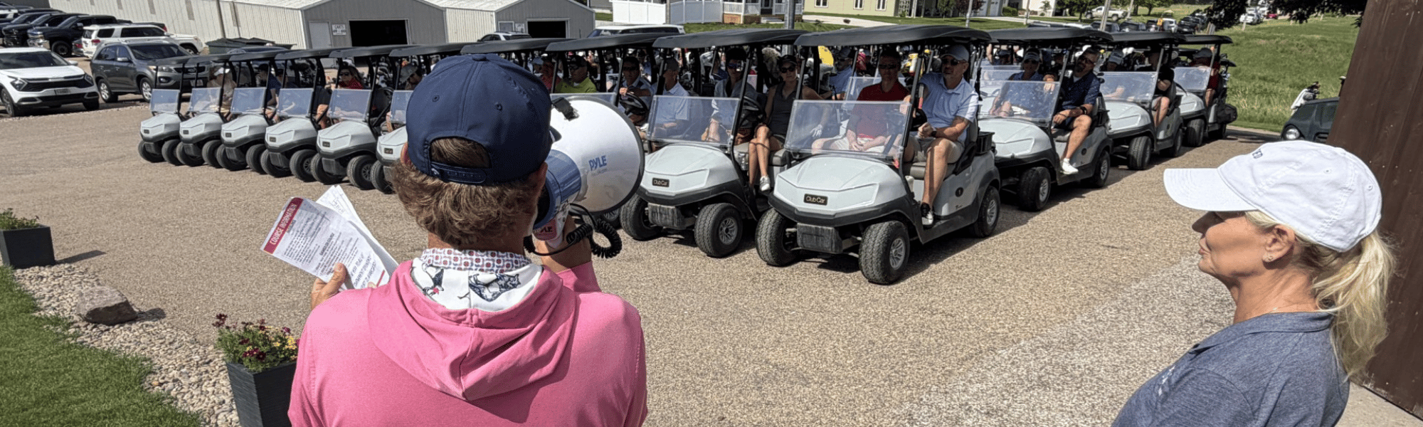 Golfers in the 39th Annual Heartland United Way Golf Tournament listen to instructions.