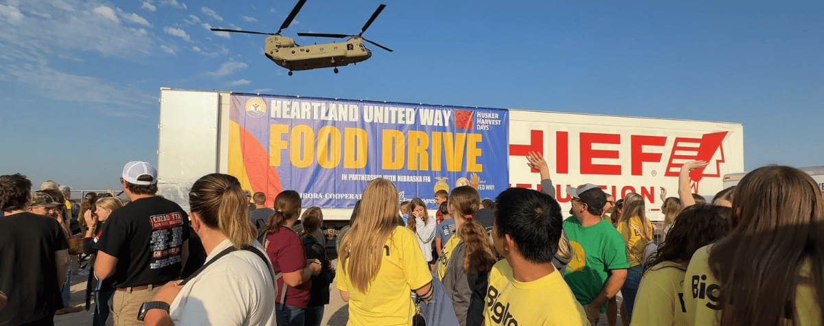 FFA members pause as a chinook flies overhead during Husker Harvest Days 2025.