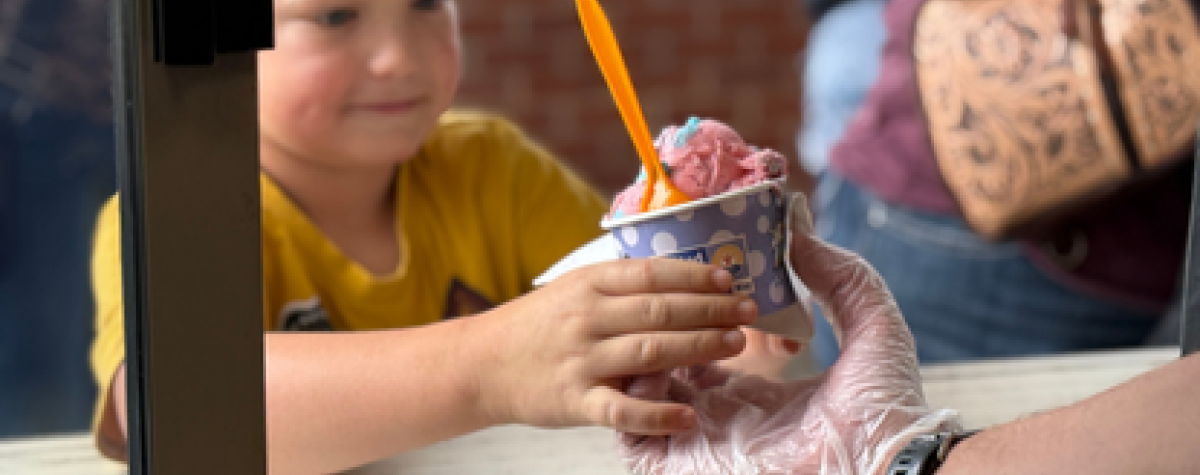 Elijah Wachter of Ravenna receives Scoops ice cream.