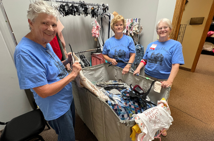 Volunteers sort clothes for Crossroads Mission Avenue during Day of Action 2025.