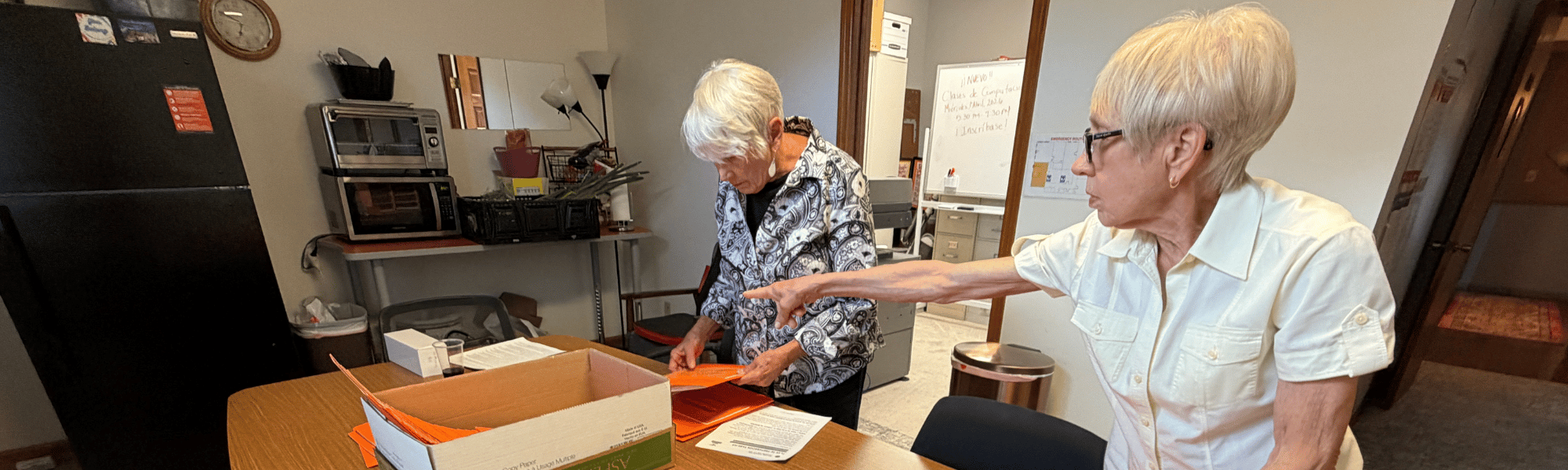 Two women put together packets during Day of Action 2026.