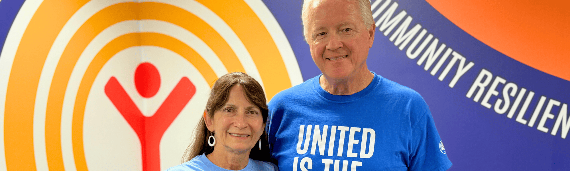 Kent and Tonja Brown stand in shirts with United Is The Way written on them.