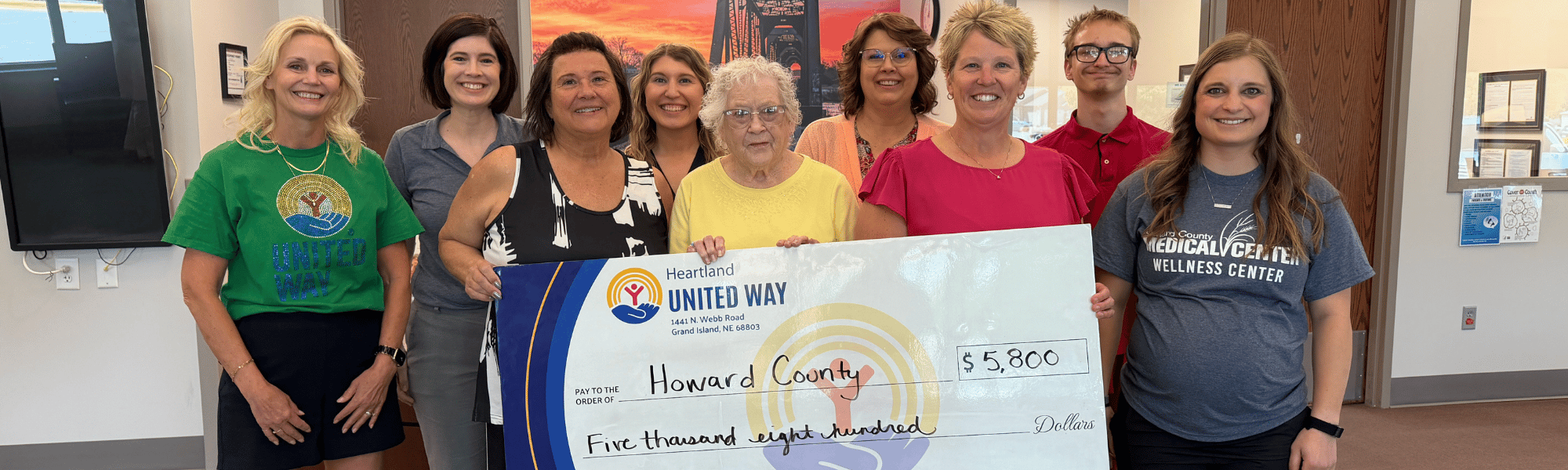Howard County nonprofits pose for a picture with a giant Heartland United Way check.