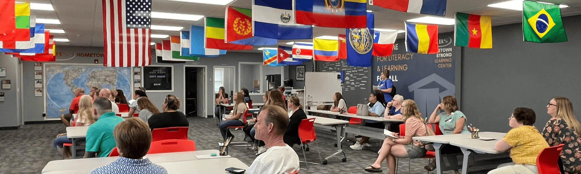 Tour of Agency 2024 participants sit at tables at the Literacy Council of Grand Island.
