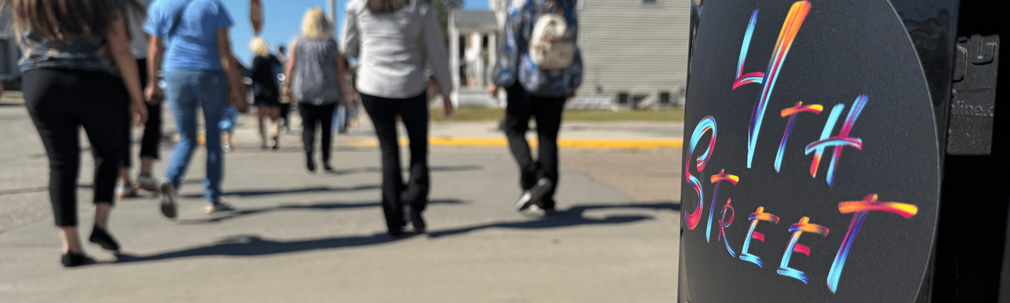A group of people tour 4th Street in Grand Island, Nebraska in 2025.