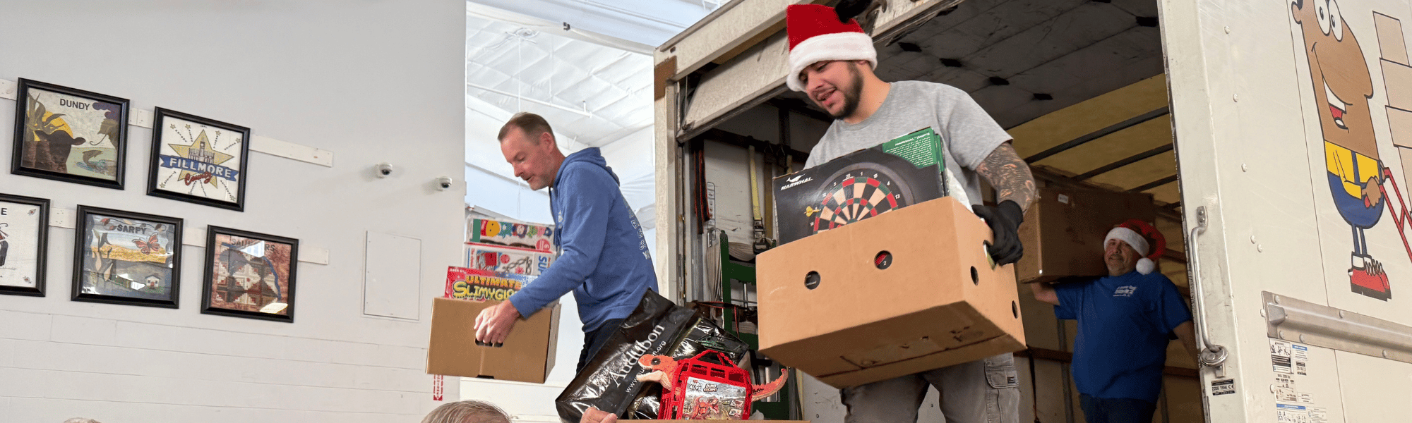 Volunteers hand boxes of toys to other volunteers during Heartland United Way Toy Collection 2025.