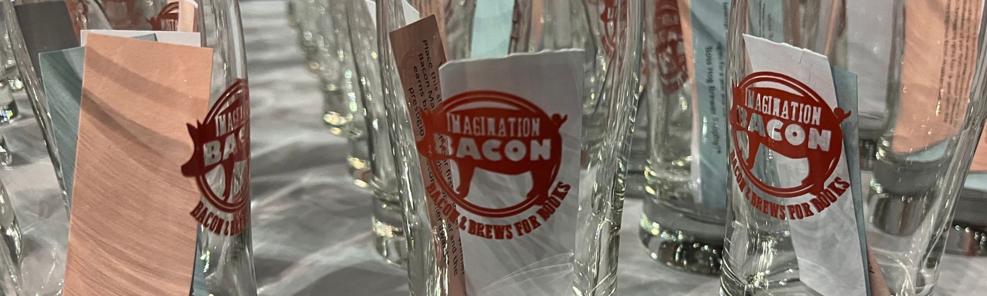Imagination Bacon event cups are displayed on a table in 2024.