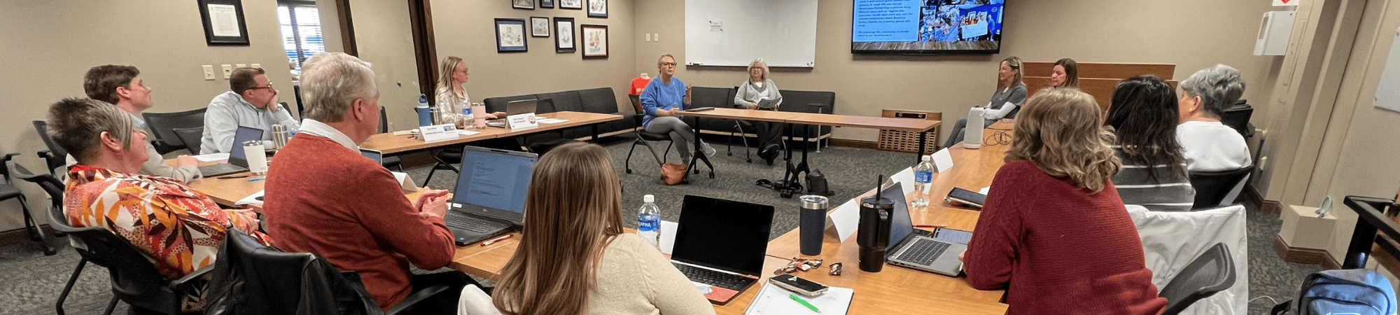 Volunteers listen to presentations from nonprofits during Community Investment process 2025