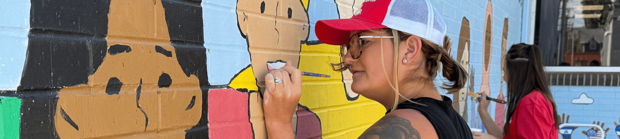 Staff from Lisa Willman State Farm retouched a mural at Literacy Council for Day of Action 2026.