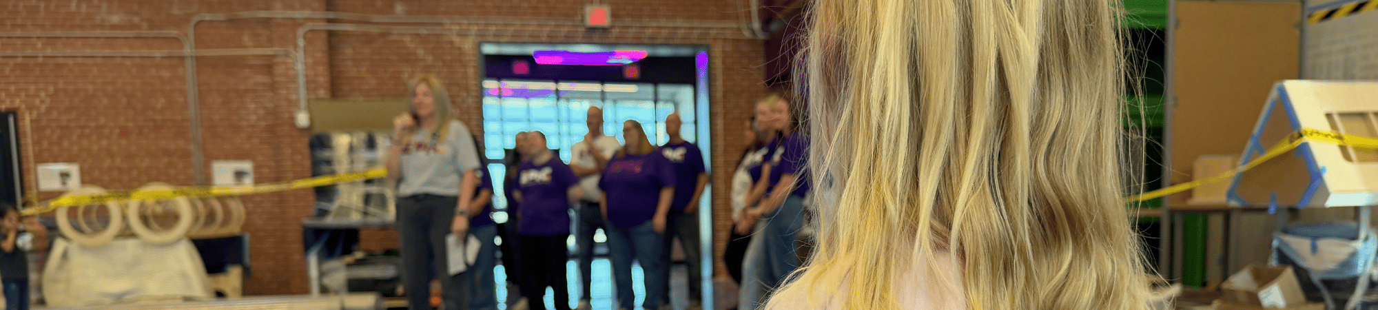 A child looks on as Go Big GIVE participants EPIC Discovery Center announces their opening date.