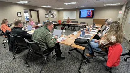 Volunteers hear from a Heartland United Way community partner.