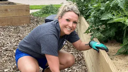 A volunteer helps weed during Day of Action 2024.