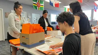 Volunteers gather to assemble packets for the Multicultural Coalition during Day of Action 2025.