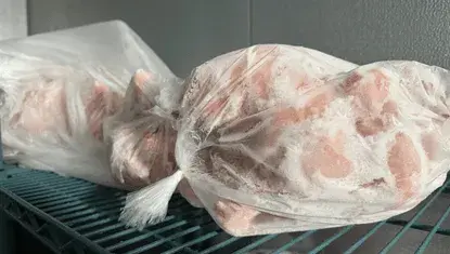 Frozen chickens sit in a freezer