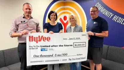HyVee presents a $1,000 check made out to United After the Storm Fund to Heartland United Way staff.